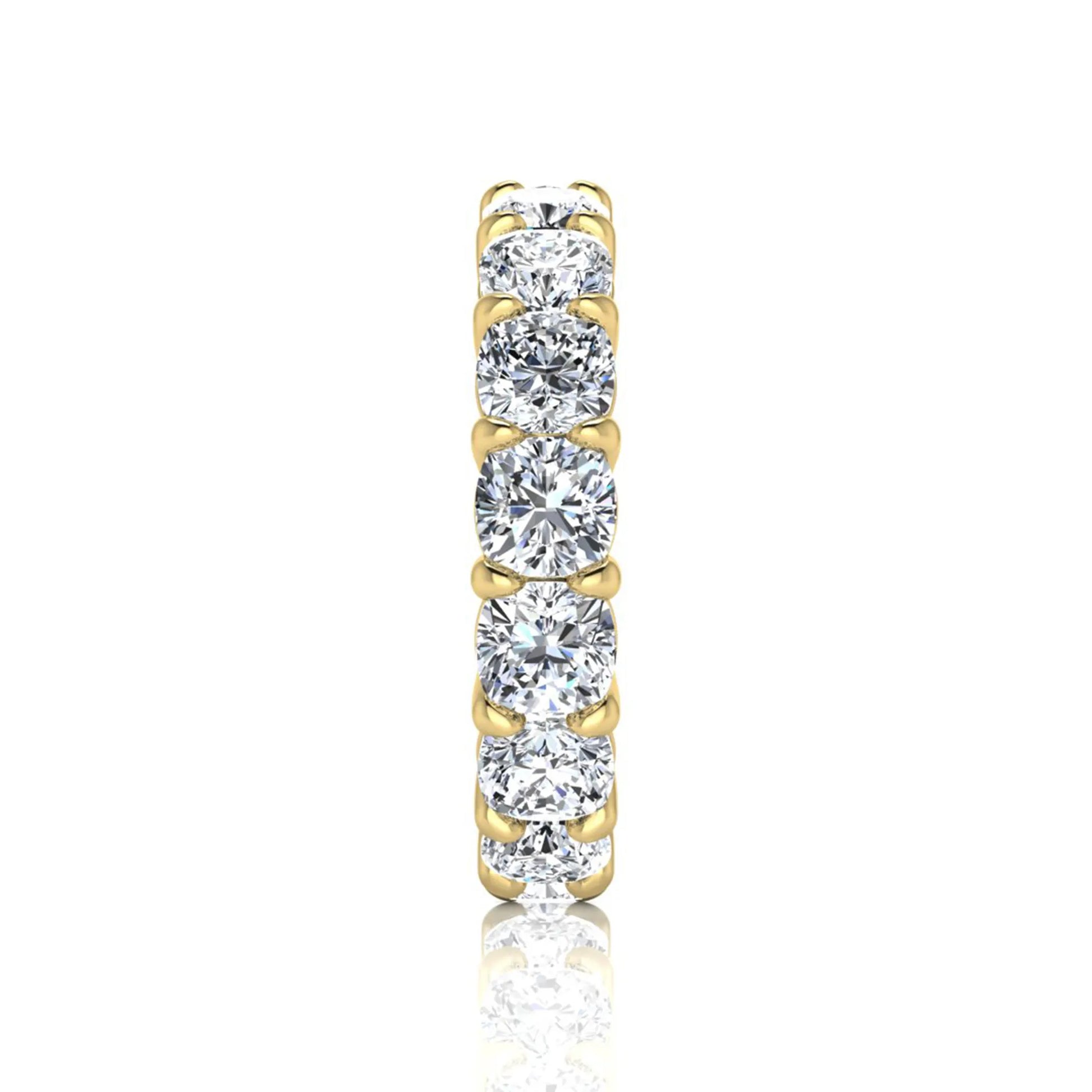 Cushion cut lab grown diamond eternity band ring featuring shared prong set diamonds with a yellow gold tone design.