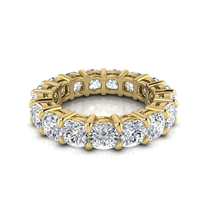 Cushion cut lab grown diamond eternity band ring featuring shared prong set diamonds with a yellow gold tone design.