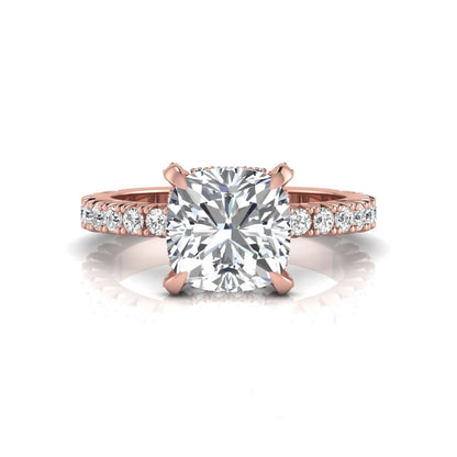 Cushion cut lab grown diamond engagement ring featuring a four-prong setting with round pavé side diamonds and rose gold tone band.