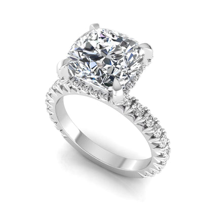 Cushion cut lab grown diamond engagement ring featuring a four-prong setting with round pavé side diamonds and white gold tone band.