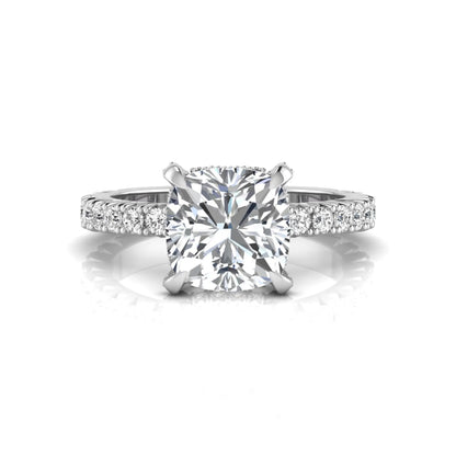 Cushion cut lab grown diamond engagement ring featuring a four-prong setting with round pavé side diamonds and white gold tone band.