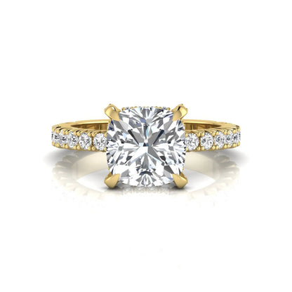 Cushion cut lab grown diamond engagement ring featuring a four-prong setting with round pavé side diamonds and yellow gold tone band.