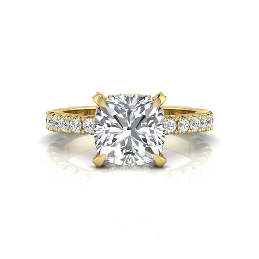 Cushion cut lab grown diamond engagement ring featuring a four-prong setting with round pavé side diamonds and yellow gold tone band.