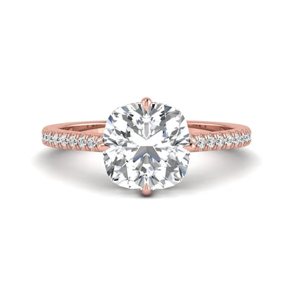 Cushion cut lab grown diamond hidden halo engagement ring featuring a 2.75 carat IGI certified center diamond with a pavé diamond band in rose gold.