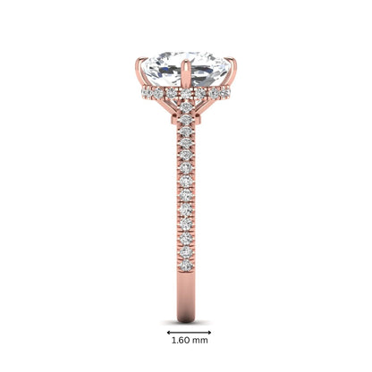 Cushion cut lab grown diamond hidden halo engagement ring featuring a 2.75 carat IGI certified center diamond with a pavé diamond band in rose gold.