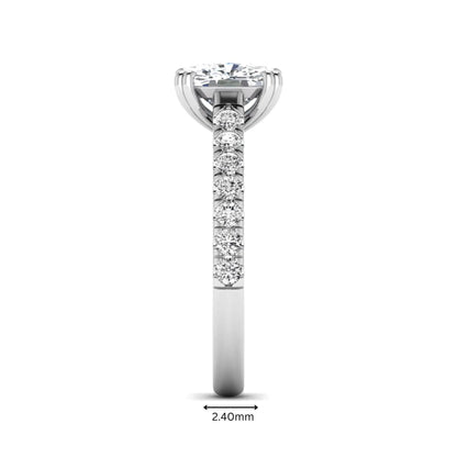 IGI certified cushion cut lab grown diamond solitaire accent engagement ring with pavé round diamond band in white gold.