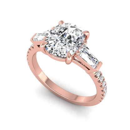 Cushion cut three stone lab grown diamond engagement ring featuring a 3.06 carat IGI certified cushion cut center diamond with tapered baguette side diamonds and pavé shank in rose gold.