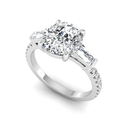 Cushion cut three stone lab grown diamond engagement ring featuring a 3.06 carat IGI certified cushion cut center diamond with tapered baguette side diamonds and pavé shank in white gold.