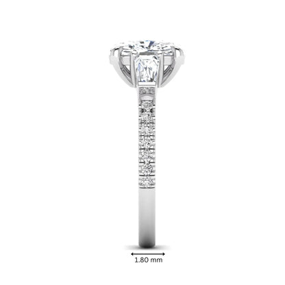Cushion cut three stone lab grown diamond engagement ring featuring a 3.06 carat IGI certified cushion cut center diamond with tapered baguette side diamonds and pavé shank in white gold.