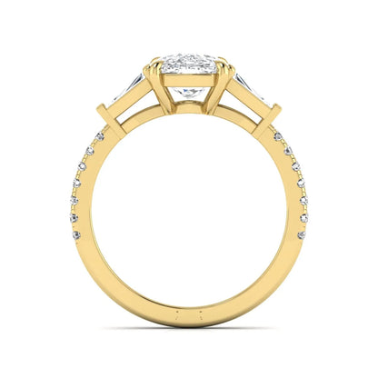 Cushion cut three stone lab grown diamond engagement ring featuring a 3.06 carat IGI certified cushion cut center diamond with tapered baguette side diamonds and pavé shank in yellow gold.