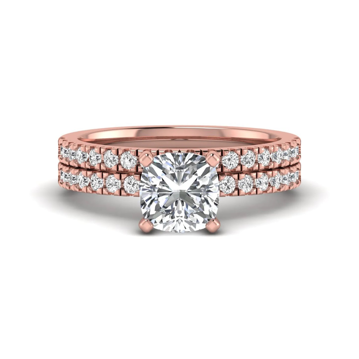 Cushion cut lab grown diamond bridal ring set featuring a four-prong solitaire engagement ring with a matching pavé diamond wedding band in a rose gold tone design.