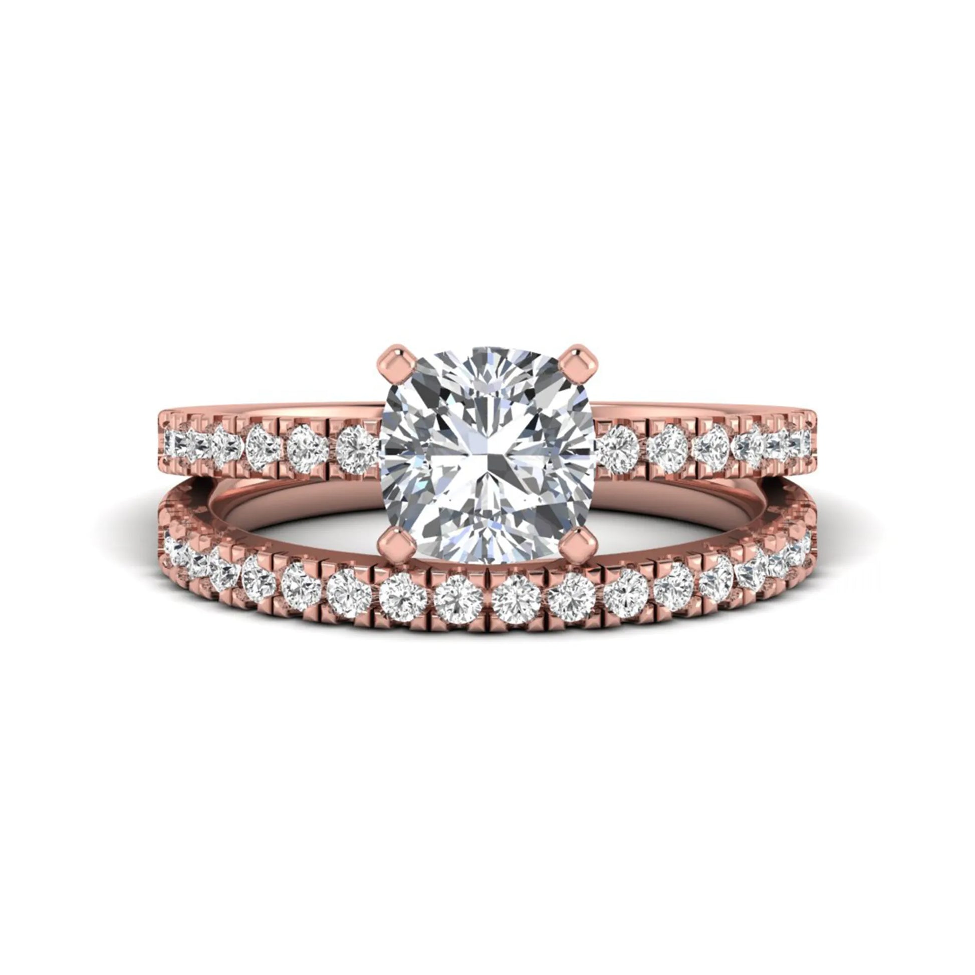 Cushion cut lab grown diamond bridal ring set featuring a four-prong solitaire engagement ring with a matching pavé diamond wedding band in a rose gold tone design.