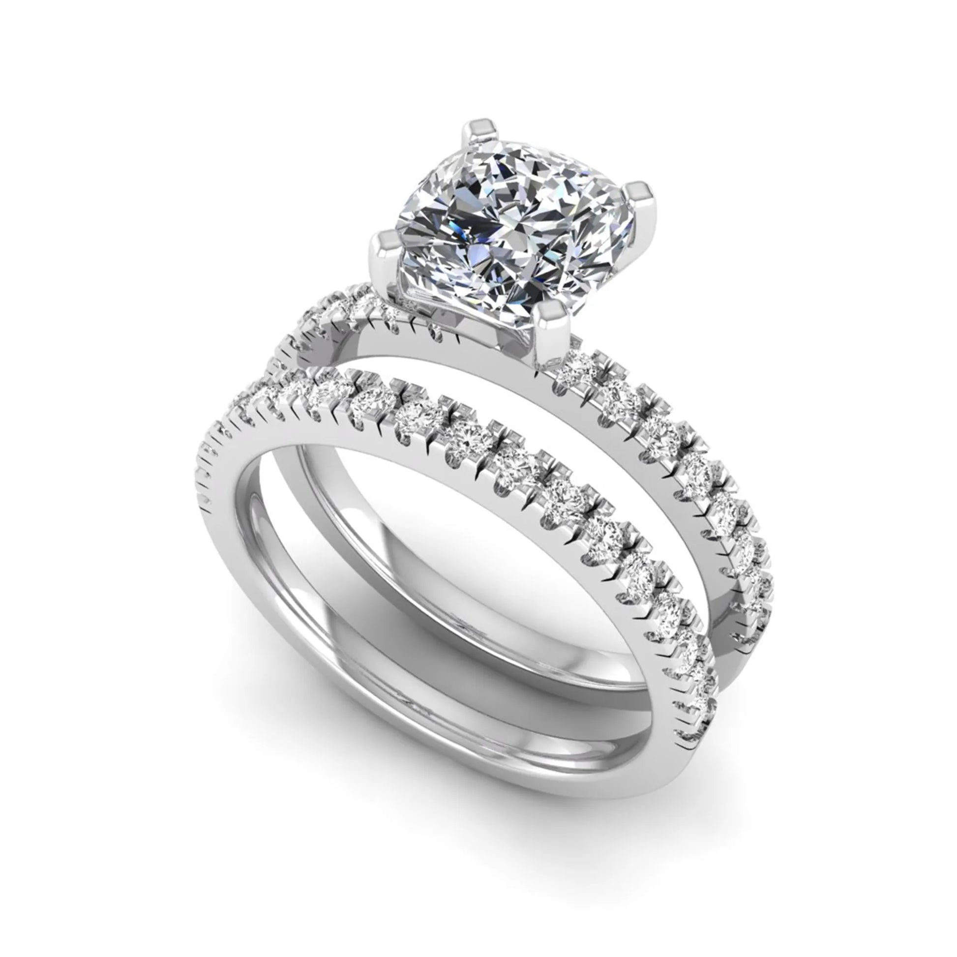 Cushion cut lab grown diamond bridal ring set featuring a four-prong solitaire engagement ring with a matching pavé diamond wedding band in a white gold tone design.