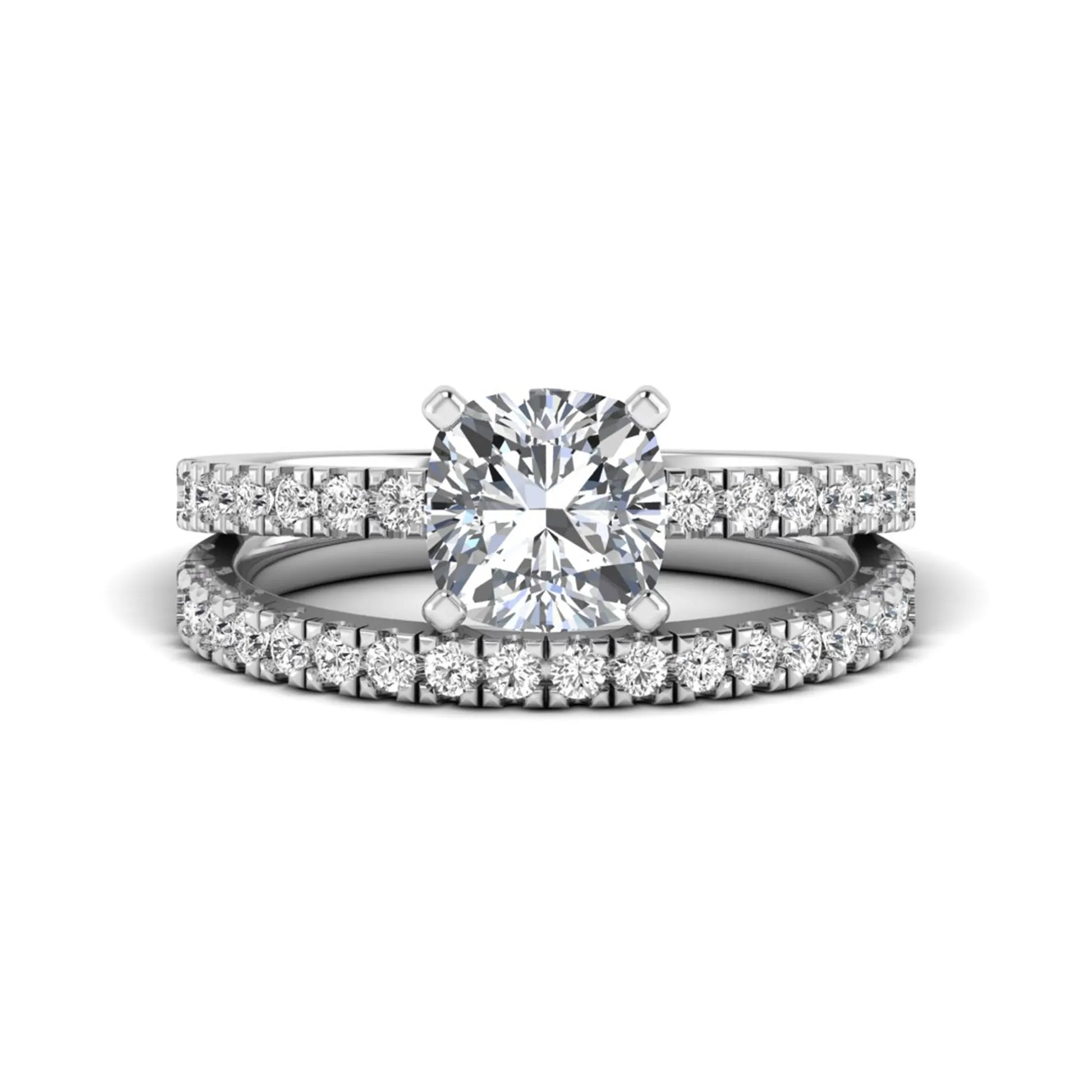Cushion cut lab grown diamond bridal ring set featuring a four-prong solitaire engagement ring with a matching pavé diamond wedding band in a white gold tone design.