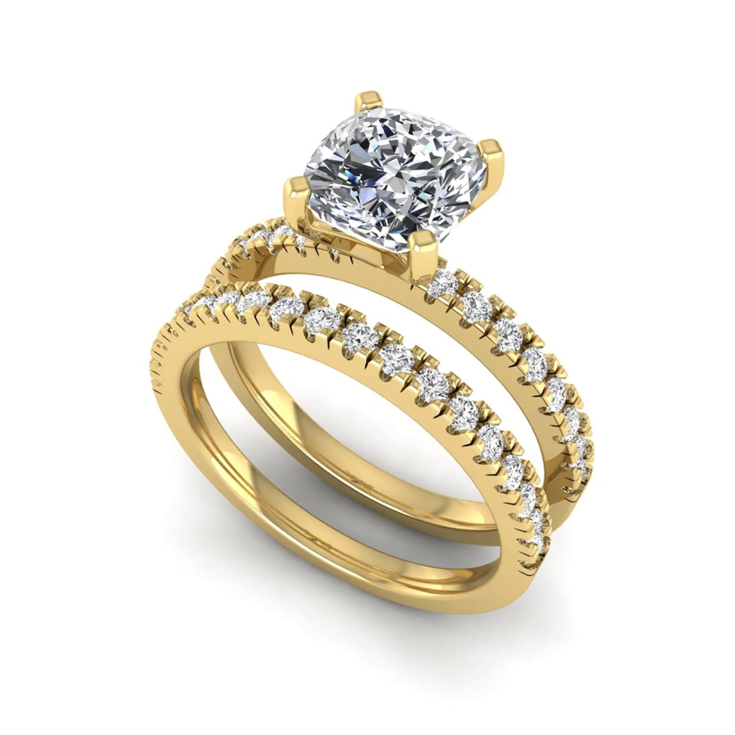 Cushion cut lab grown diamond bridal ring set featuring a four-prong solitaire engagement ring with a matching pavé diamond wedding band in a yellow gold tone design.