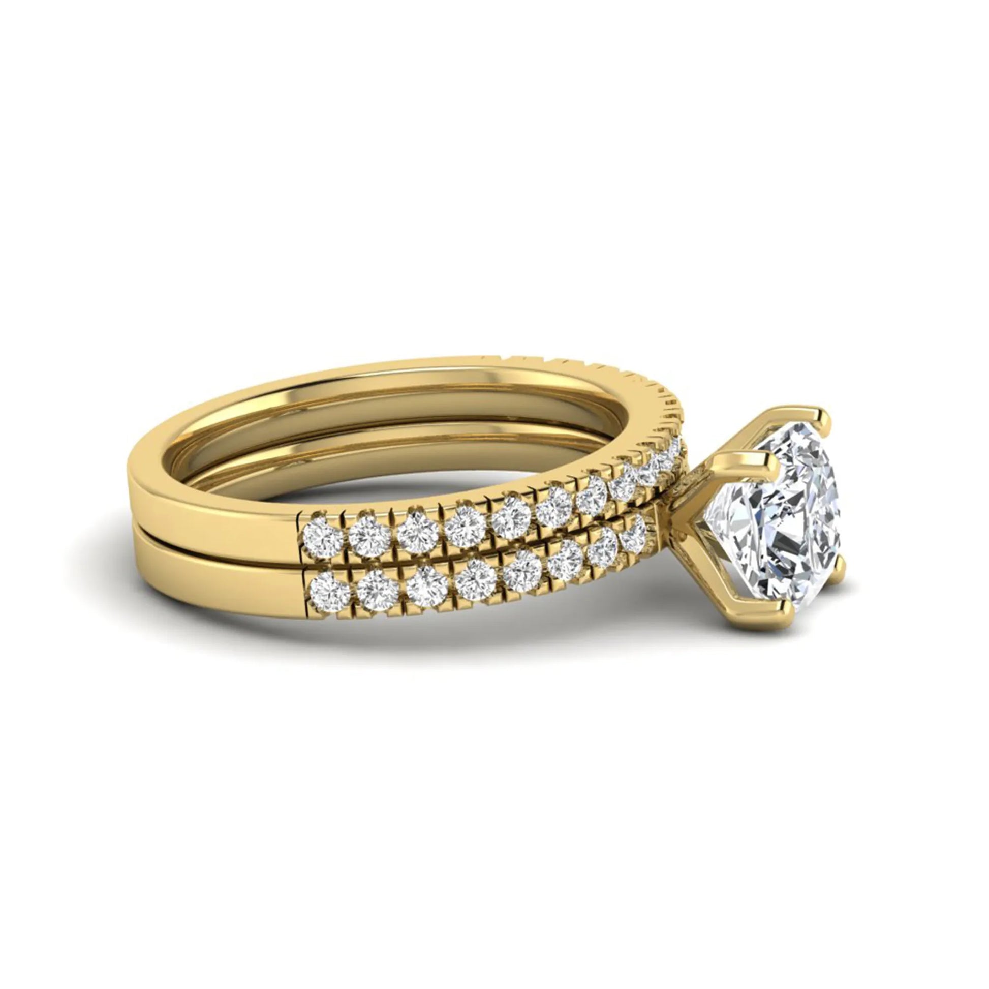 Cushion cut lab grown diamond bridal ring set featuring a four-prong solitaire engagement ring with a matching pavé diamond wedding band in a yellow gold tone design.