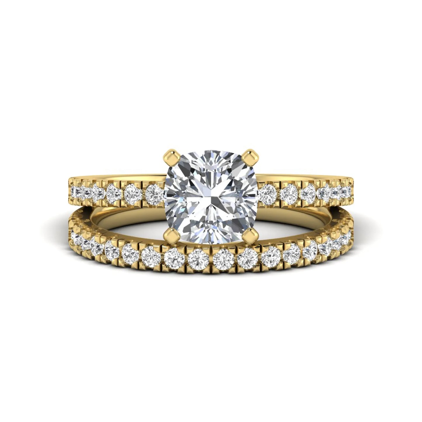 Cushion cut lab grown diamond bridal ring set featuring a four-prong solitaire engagement ring with a matching pavé diamond wedding band in a yellow gold tone design.