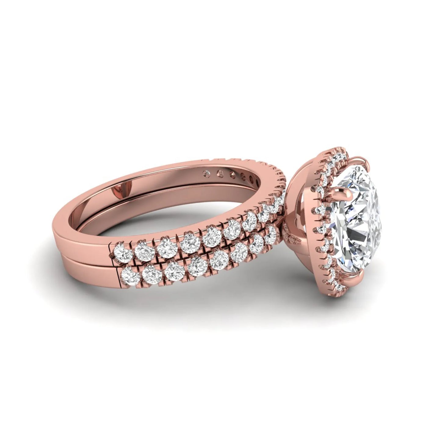 Cushion cut lab grown diamond bridal ring set featuring a halo engagement ring with a matching pavé diamond wedding band in a rose gold style design.