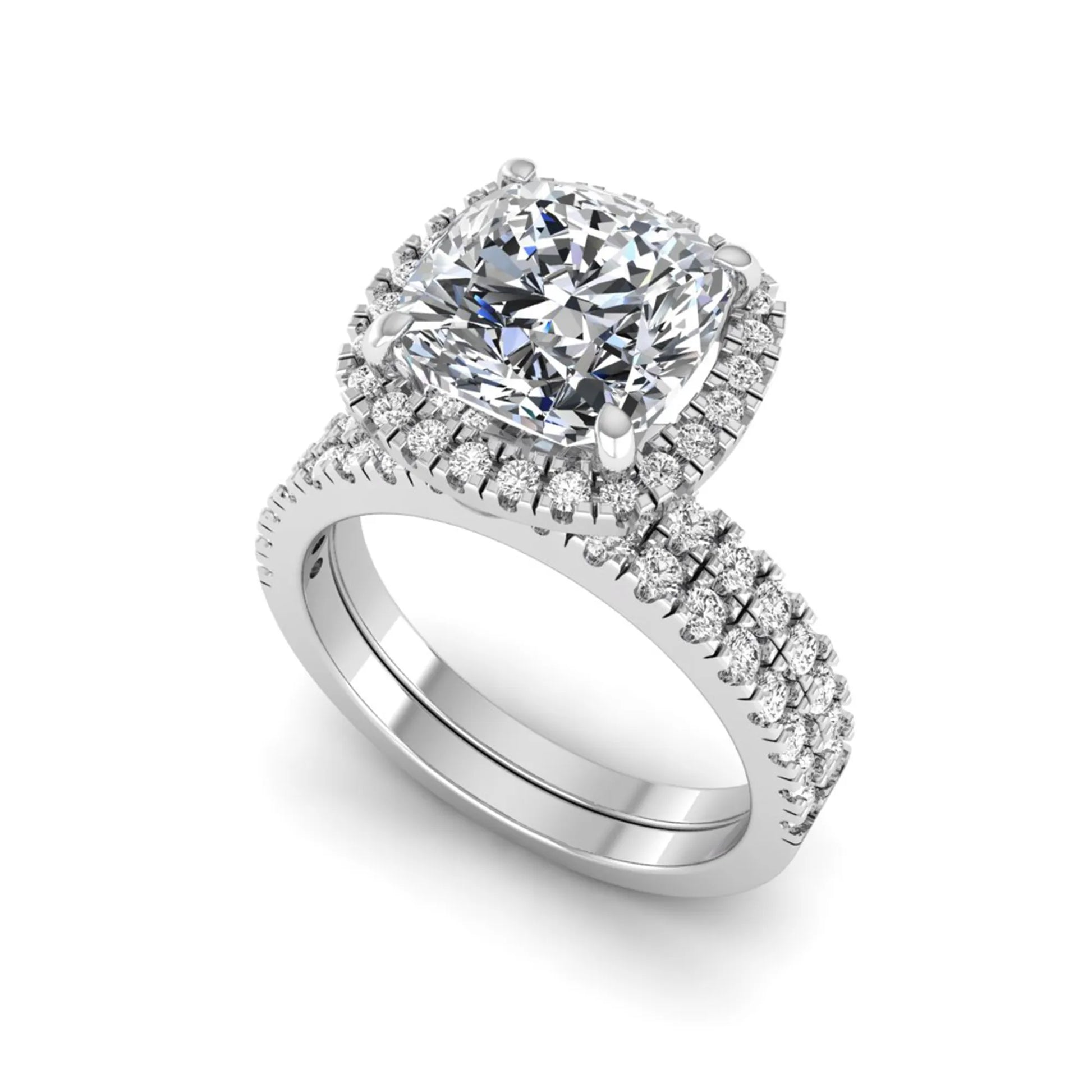 Cushion cut lab grown diamond bridal ring set featuring a halo engagement ring with a matching pavé diamond wedding band in a white gold style design.