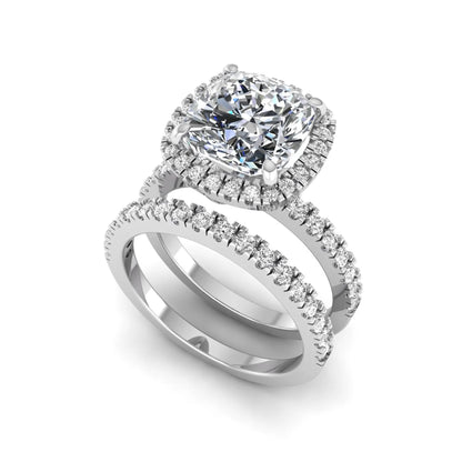 Cushion cut lab grown diamond bridal ring set featuring a halo engagement ring with a matching pavé diamond wedding band in a white gold style design.