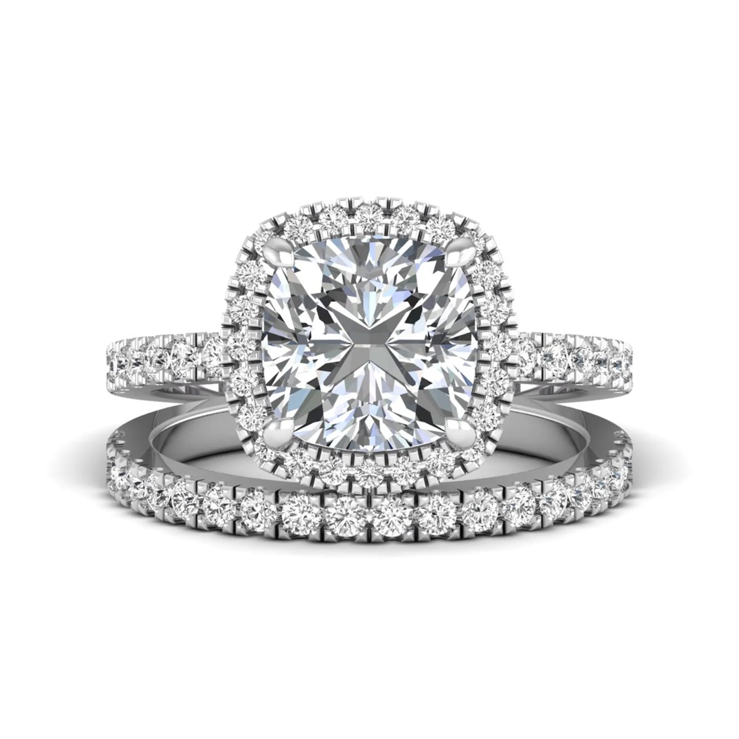 Cushion cut lab grown diamond bridal ring set featuring a halo engagement ring with a matching pavé diamond wedding band in a white gold style design.
