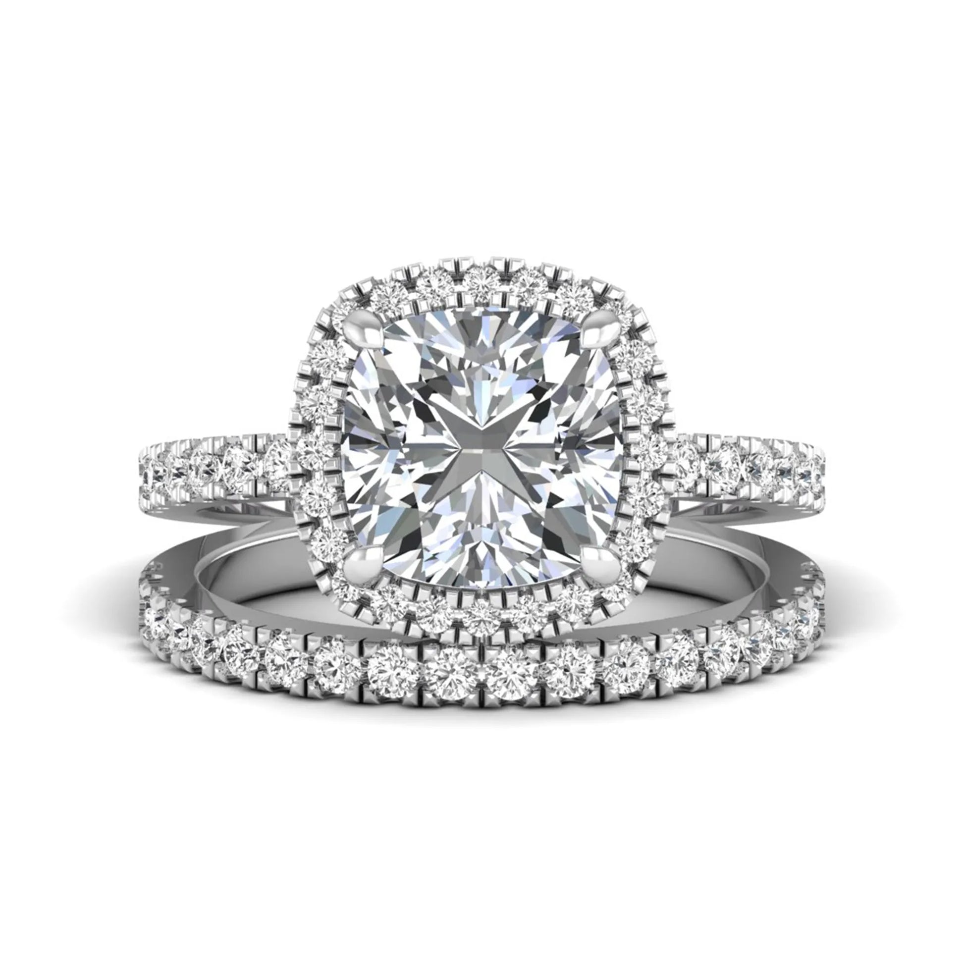Cushion cut lab grown diamond bridal ring set featuring a halo engagement ring with a matching pavé diamond wedding band in a white gold style design.
