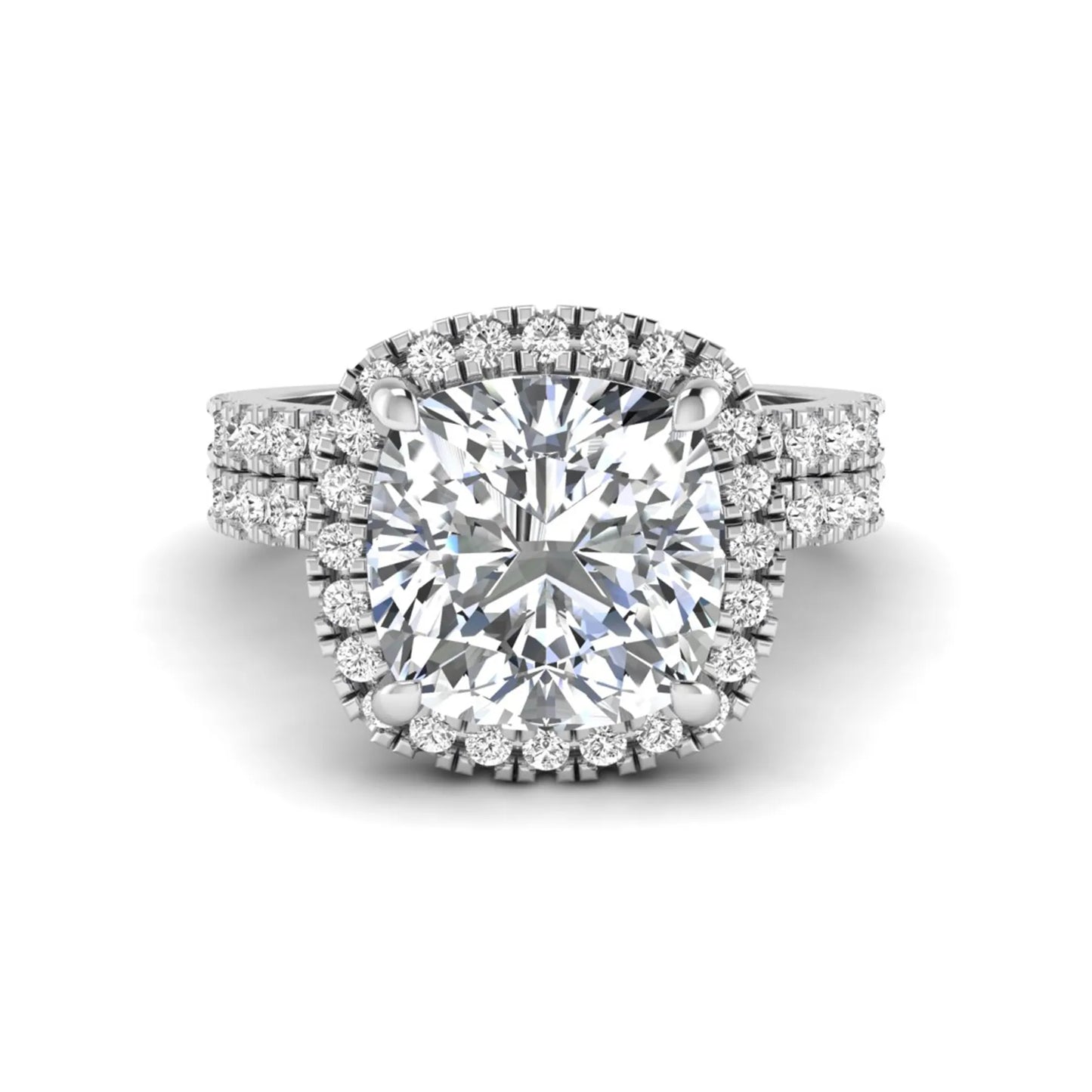 Cushion cut lab grown diamond bridal ring set featuring a halo engagement ring with a matching pavé diamond wedding band in a white gold style design.