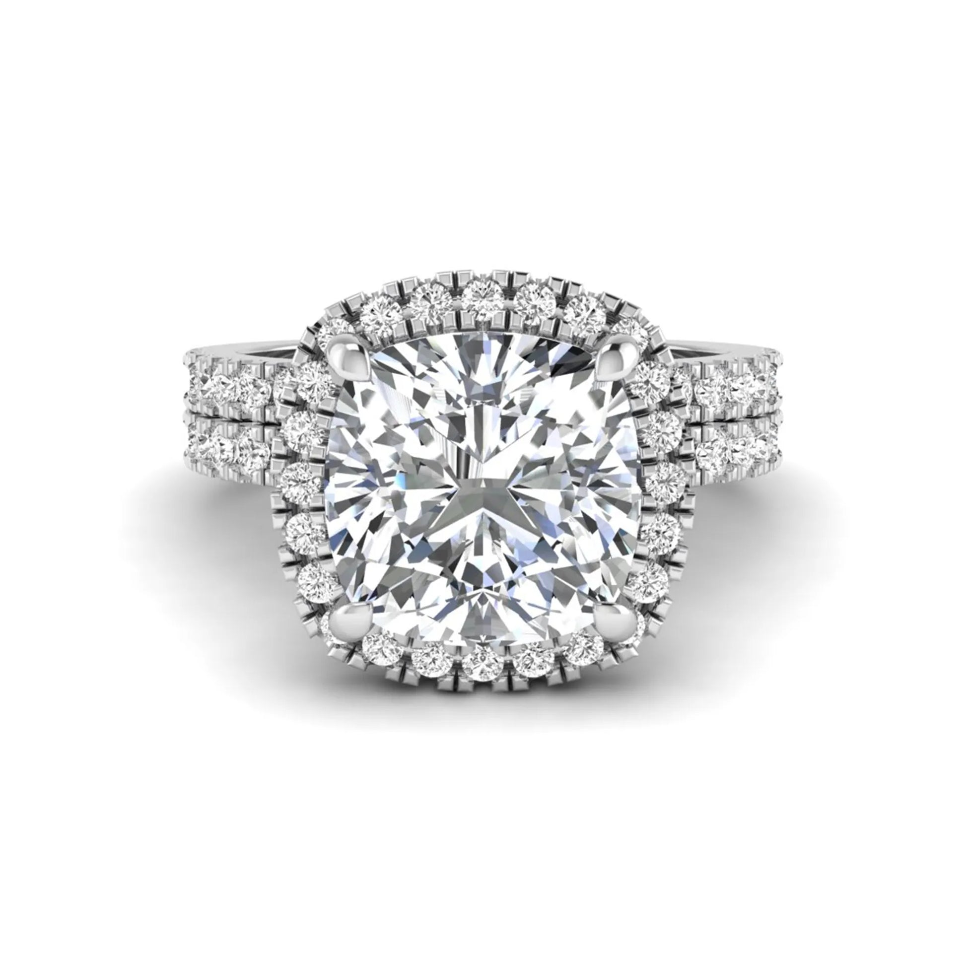 Cushion cut lab grown diamond bridal ring set featuring a halo engagement ring with a matching pavé diamond wedding band in a white gold style design.