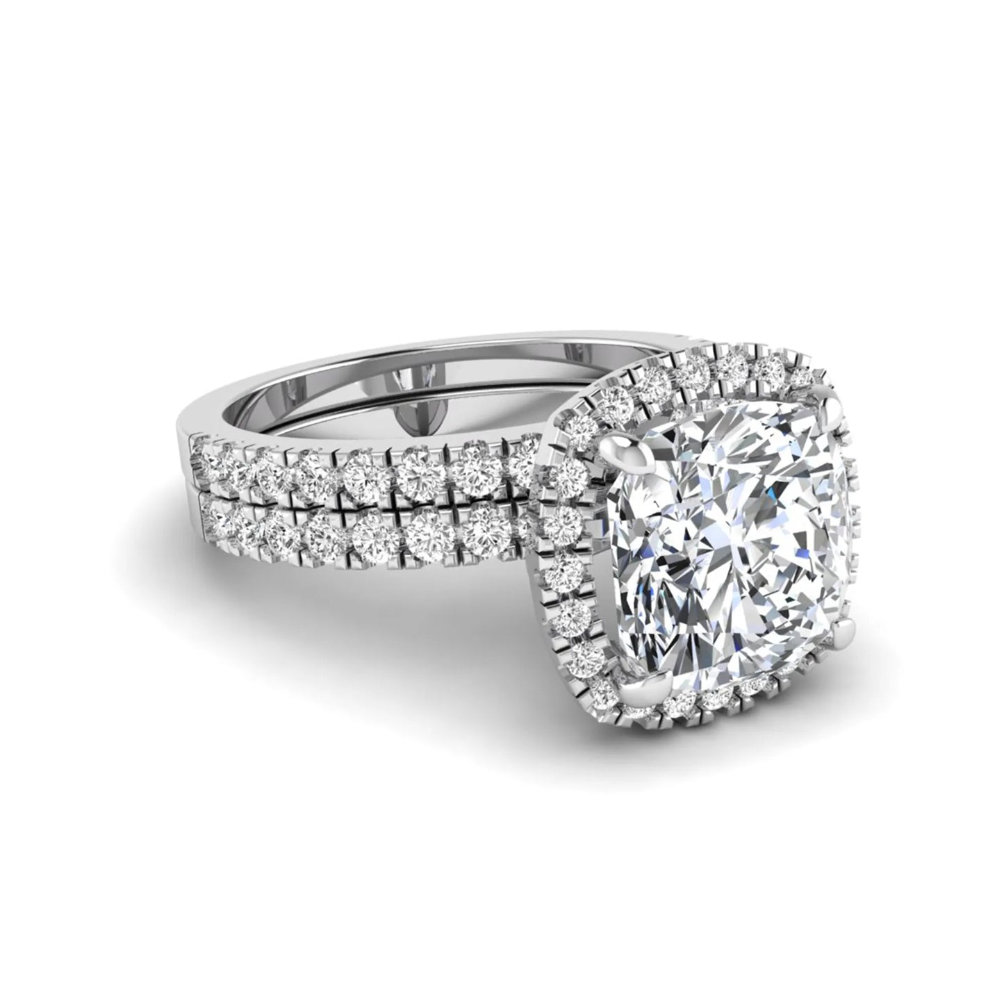 Cushion cut lab grown diamond bridal ring set featuring a halo engagement ring with a matching pavé diamond wedding band in a white gold style design.