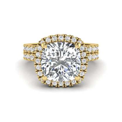 Cushion cut lab grown diamond bridal ring set featuring a halo engagement ring with a matching pavé diamond wedding band in a yellow gold style design.