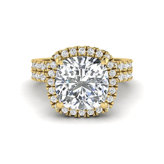 Cushion cut lab grown diamond bridal ring set featuring a halo engagement ring with a matching pavé diamond wedding band in a yellow gold style design.