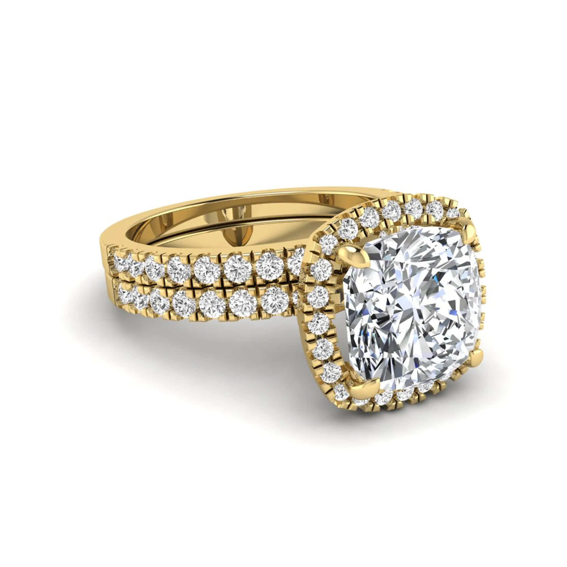 Cushion cut lab grown diamond bridal ring set featuring a halo engagement ring with a matching pavé diamond wedding band in a yellow gold style design.