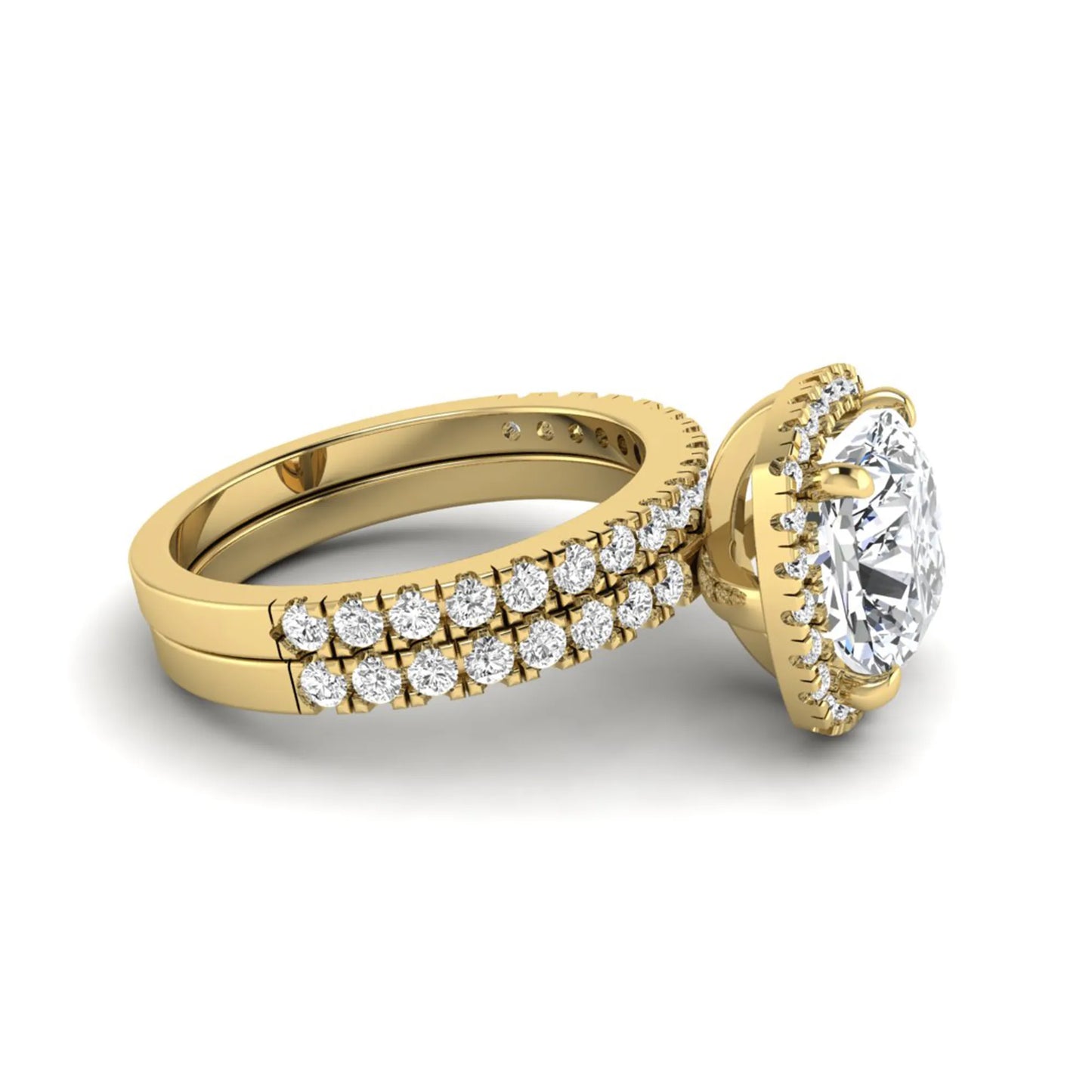Cushion cut lab grown diamond bridal ring set featuring a halo engagement ring with a matching pavé diamond wedding band in a yellow gold style design.