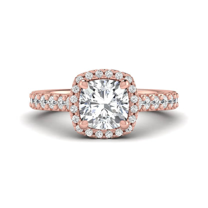Cushion cut lab grown diamond halo engagement ring featuring a four-prong center diamond, round diamond halo, and pavé diamond band in a rose gold finish.