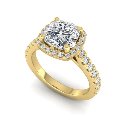 Cushion cut lab grown diamond halo engagement ring featuring a four-prong center diamond, round diamond halo, and pavé diamond band in a yellow gold finish.