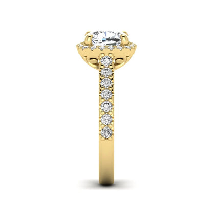 Cushion cut lab grown diamond halo engagement ring featuring a four-prong center diamond, round diamond halo, and pavé diamond band in a yellow gold finish.