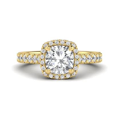 Cushion cut lab grown diamond halo engagement ring featuring a four-prong center diamond, round diamond halo, and pavé diamond band in a yellow gold finish.