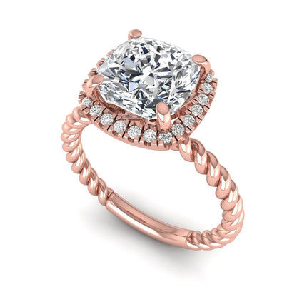 Cushion cut lab grown diamond halo engagement ring featuring a twisted rope band, four-prong setting, and round accent diamonds in a rose gold tone design.
