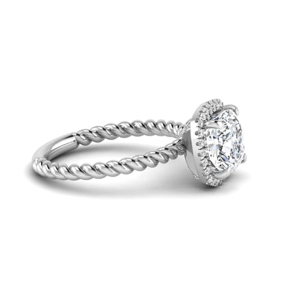 Cushion cut lab grown diamond halo engagement ring featuring a twisted rope band, four-prong setting, and round accent diamonds in a white gold tone design.