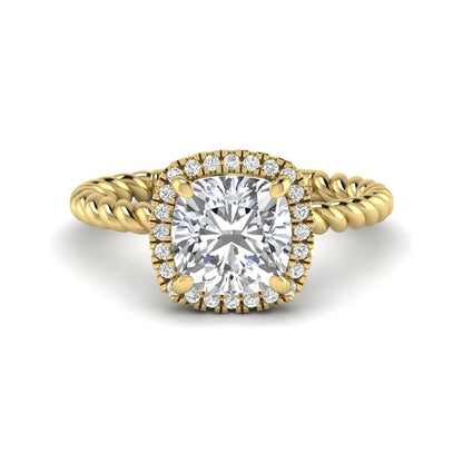 Cushion cut lab grown diamond halo engagement ring featuring a twisted rope band, four-prong setting, and round accent diamonds in a yellow gold tone design.