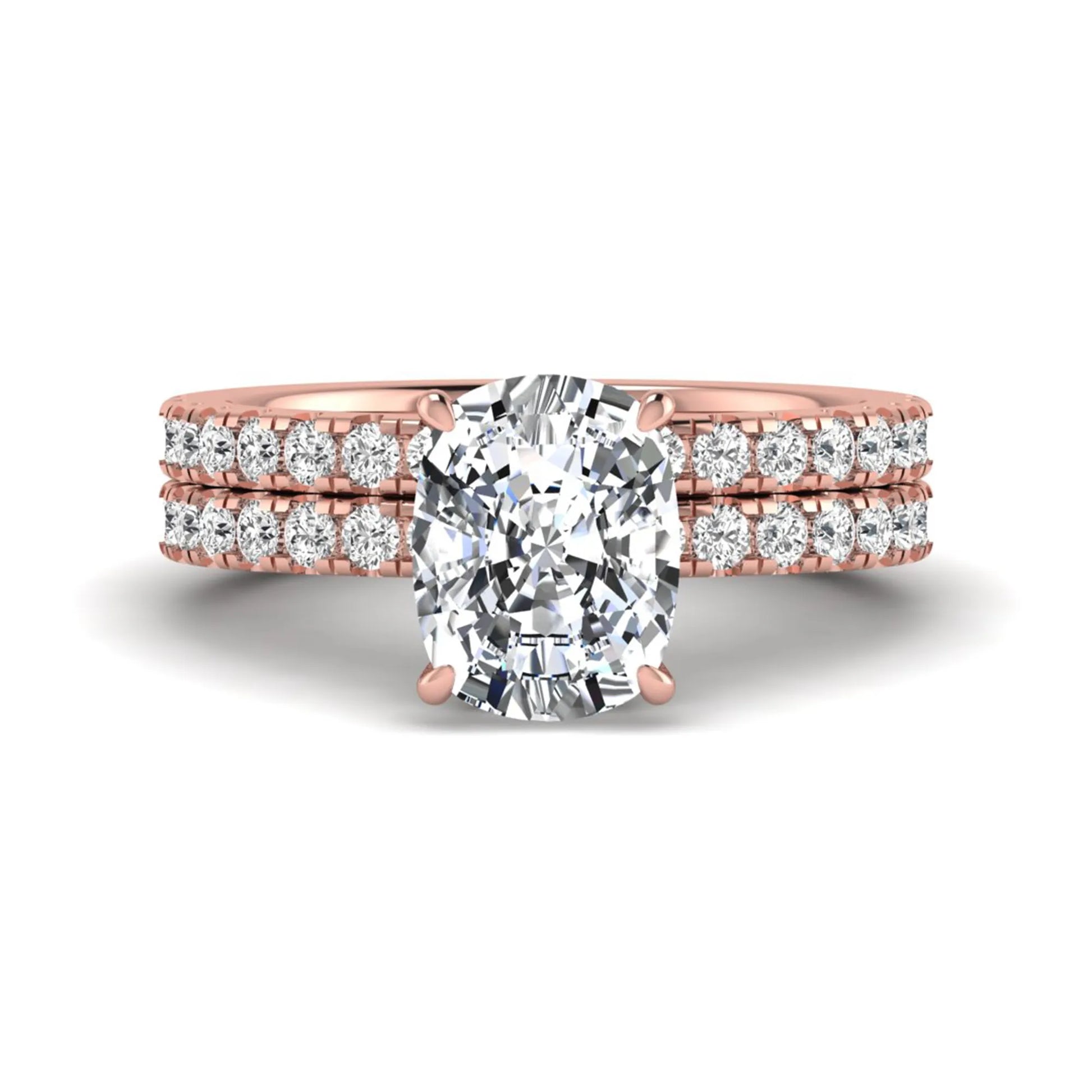 Cushion cut lab grown diamond hidden halo bridal ring set with pavé round diamonds and matching wedding band in a rose gold tone finish.