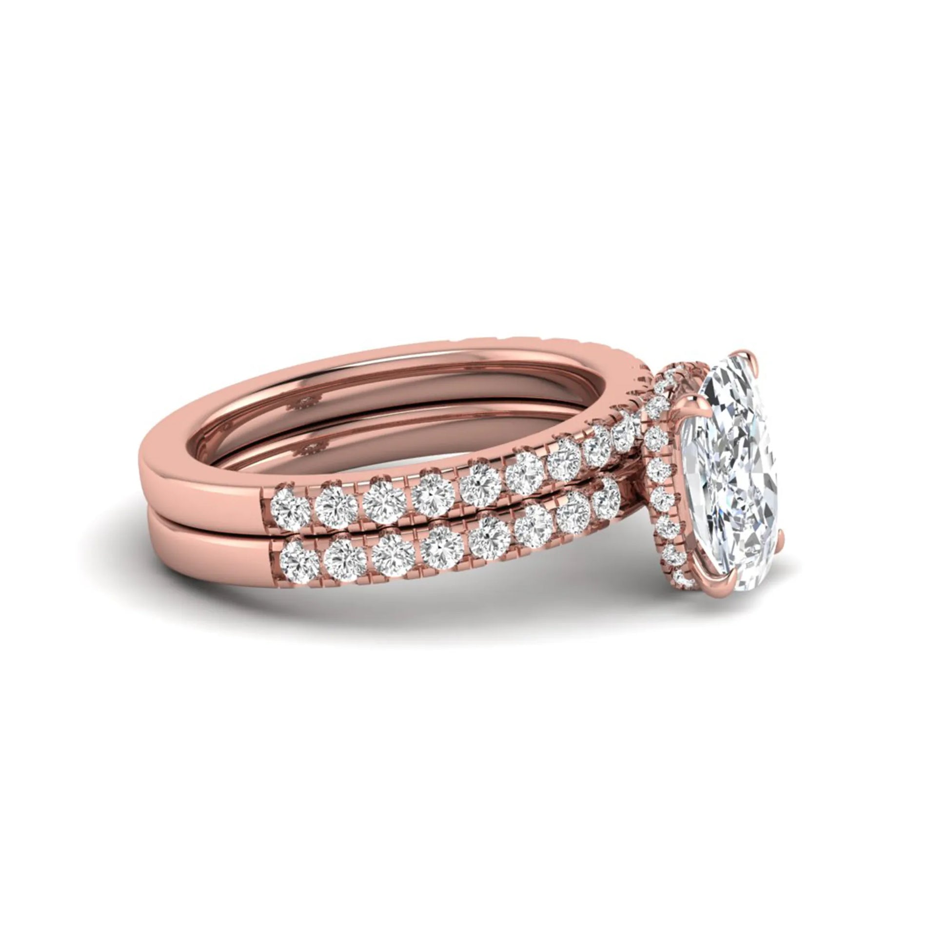 Cushion cut lab grown diamond hidden halo bridal ring set with pavé round diamonds and matching wedding band in a rose gold tone finish.