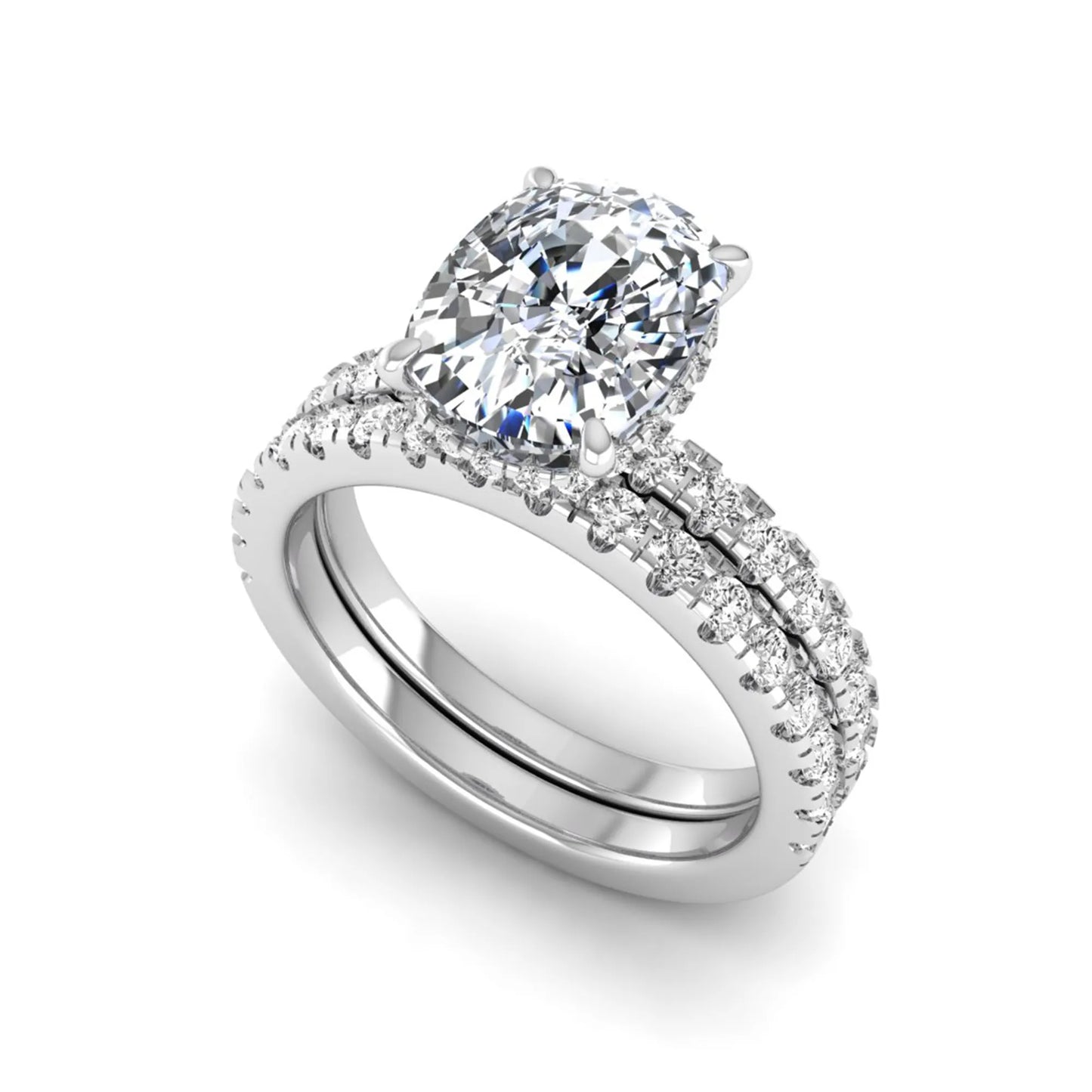 Cushion cut lab grown diamond hidden halo bridal ring set with pavé round diamonds and matching wedding band in a white gold tone finish.