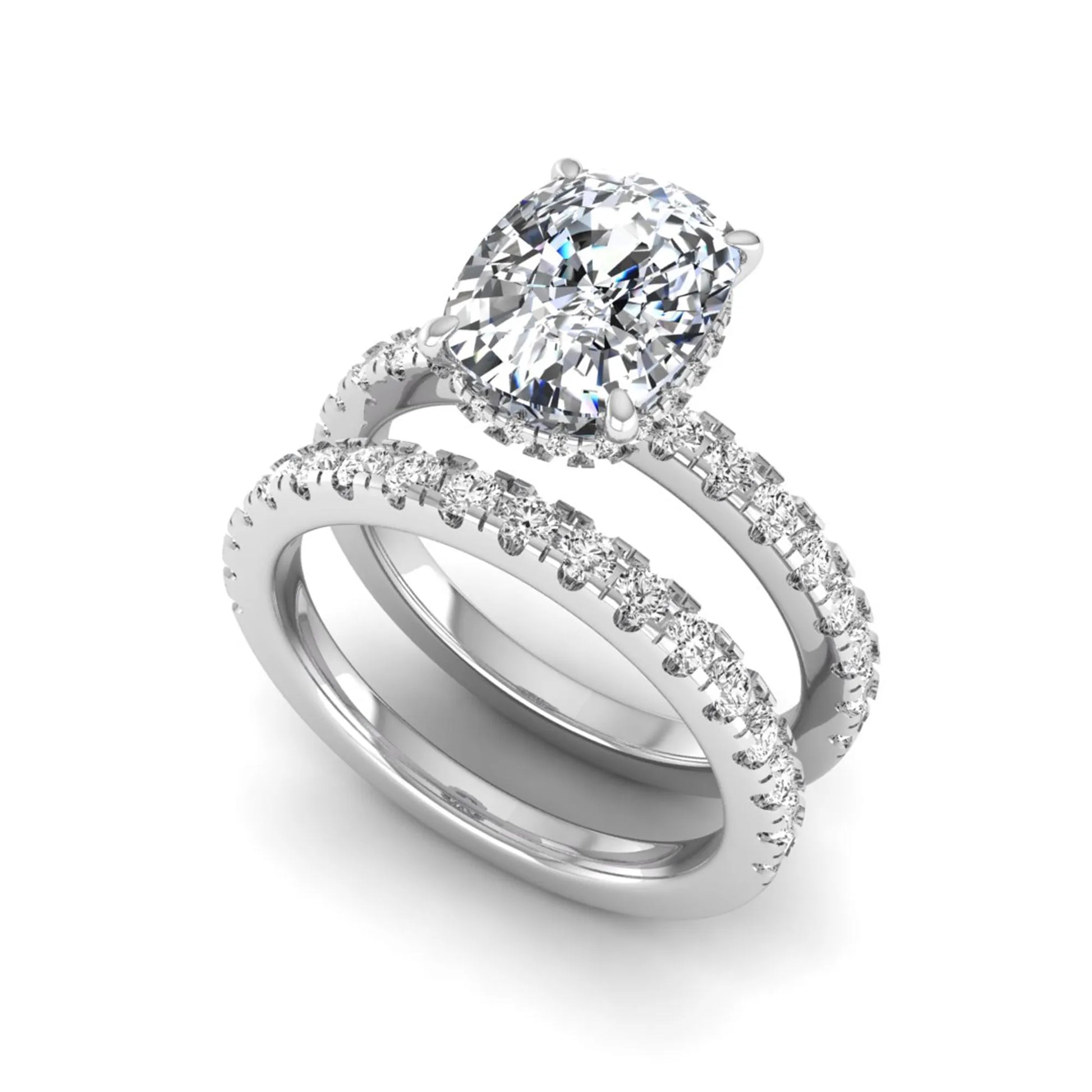 Cushion cut lab grown diamond hidden halo bridal ring set with pavé round diamonds and matching wedding band in a white gold tone finish.
