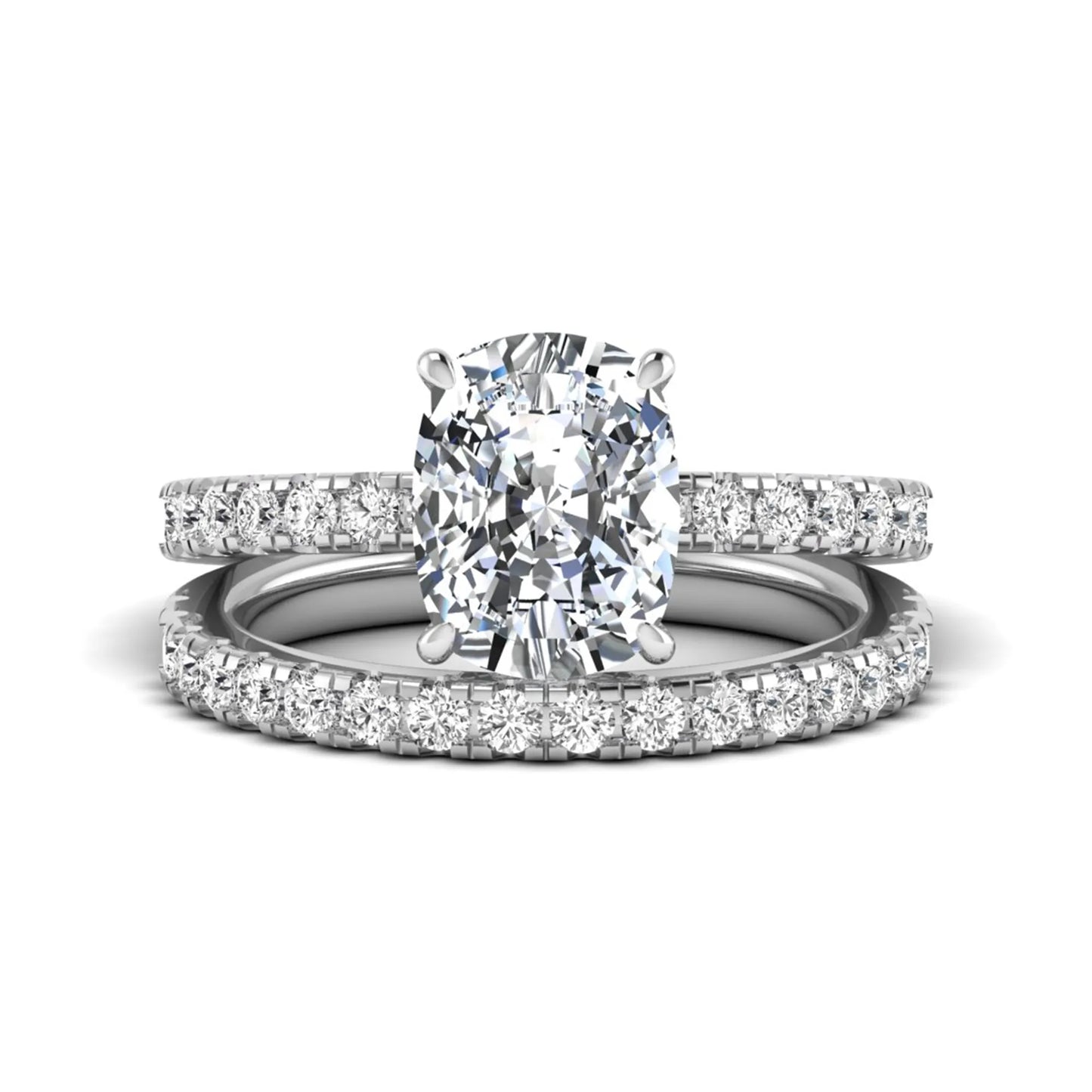 Cushion cut lab grown diamond hidden halo bridal ring set with pavé round diamonds and matching wedding band in a white gold tone finish.