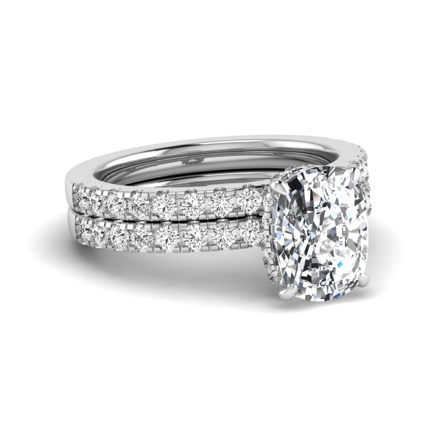 Cushion cut lab grown diamond hidden halo bridal ring set with pavé round diamonds and matching wedding band in a white gold tone finish.