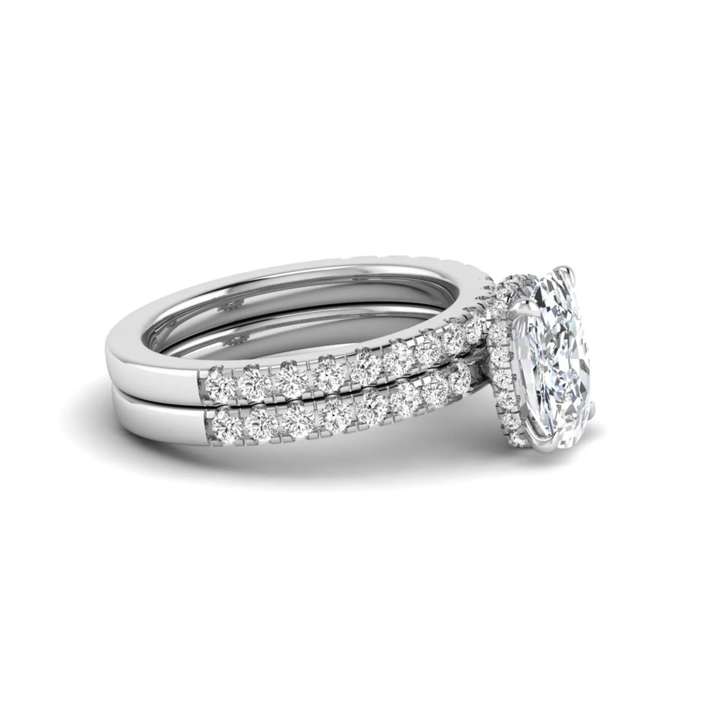 Cushion cut lab grown diamond hidden halo bridal ring set with pavé round diamonds and matching wedding band in a white gold tone finish.