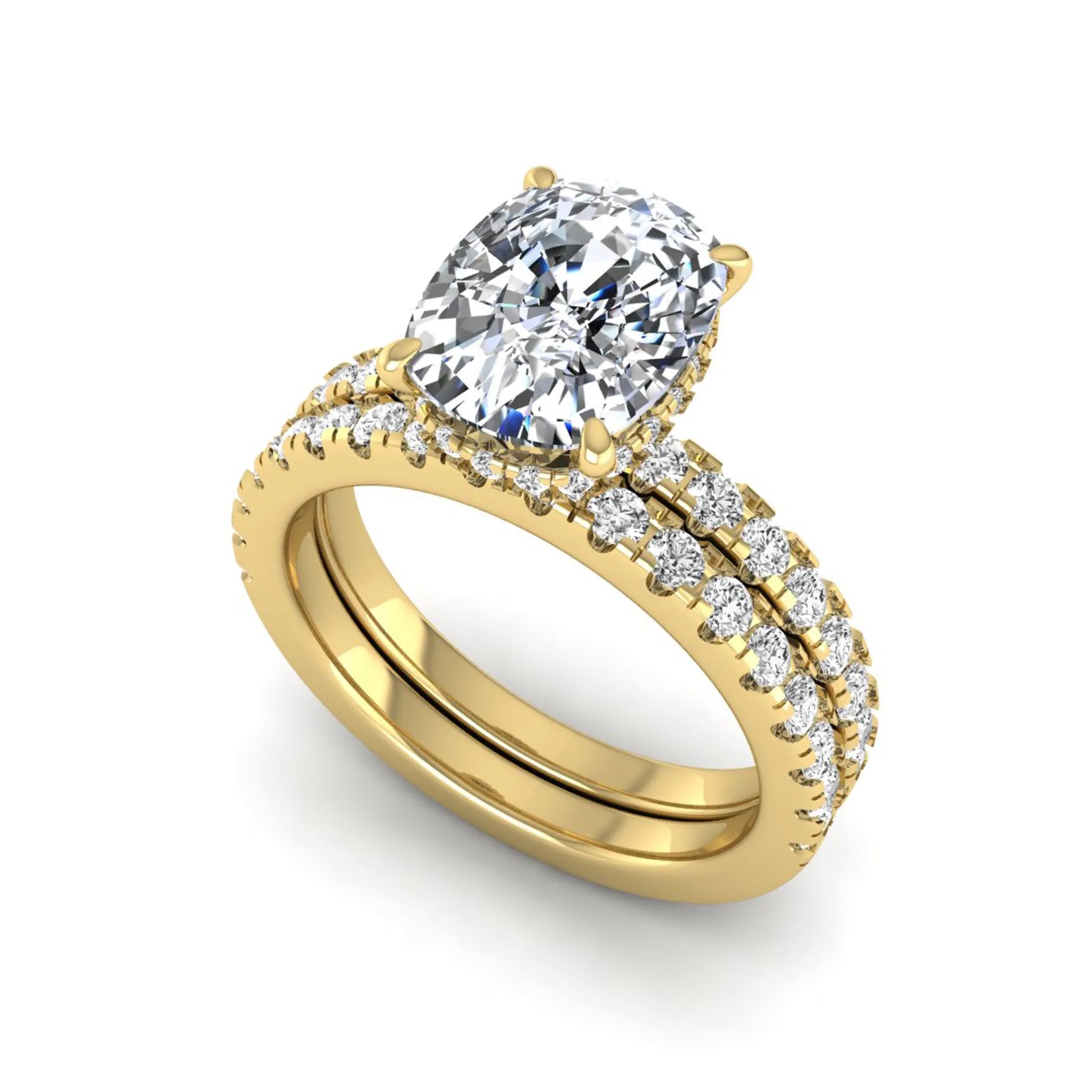 Cushion cut lab grown diamond hidden halo bridal ring set with pavé round diamonds and matching wedding band in a yellow gold tone finish.