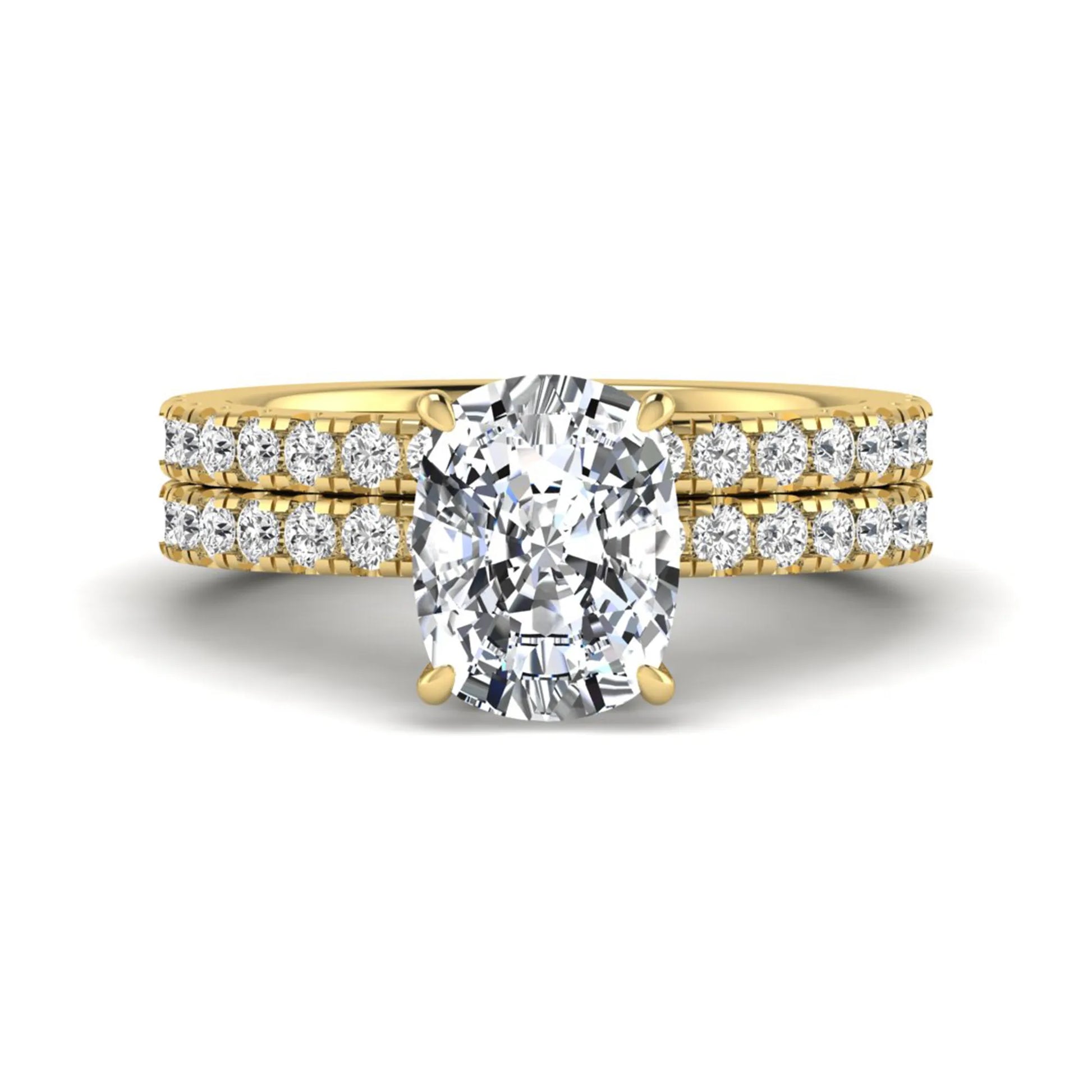 Cushion cut lab grown diamond hidden halo bridal ring set with pavé round diamonds and matching wedding band in a yellow gold tone finish.