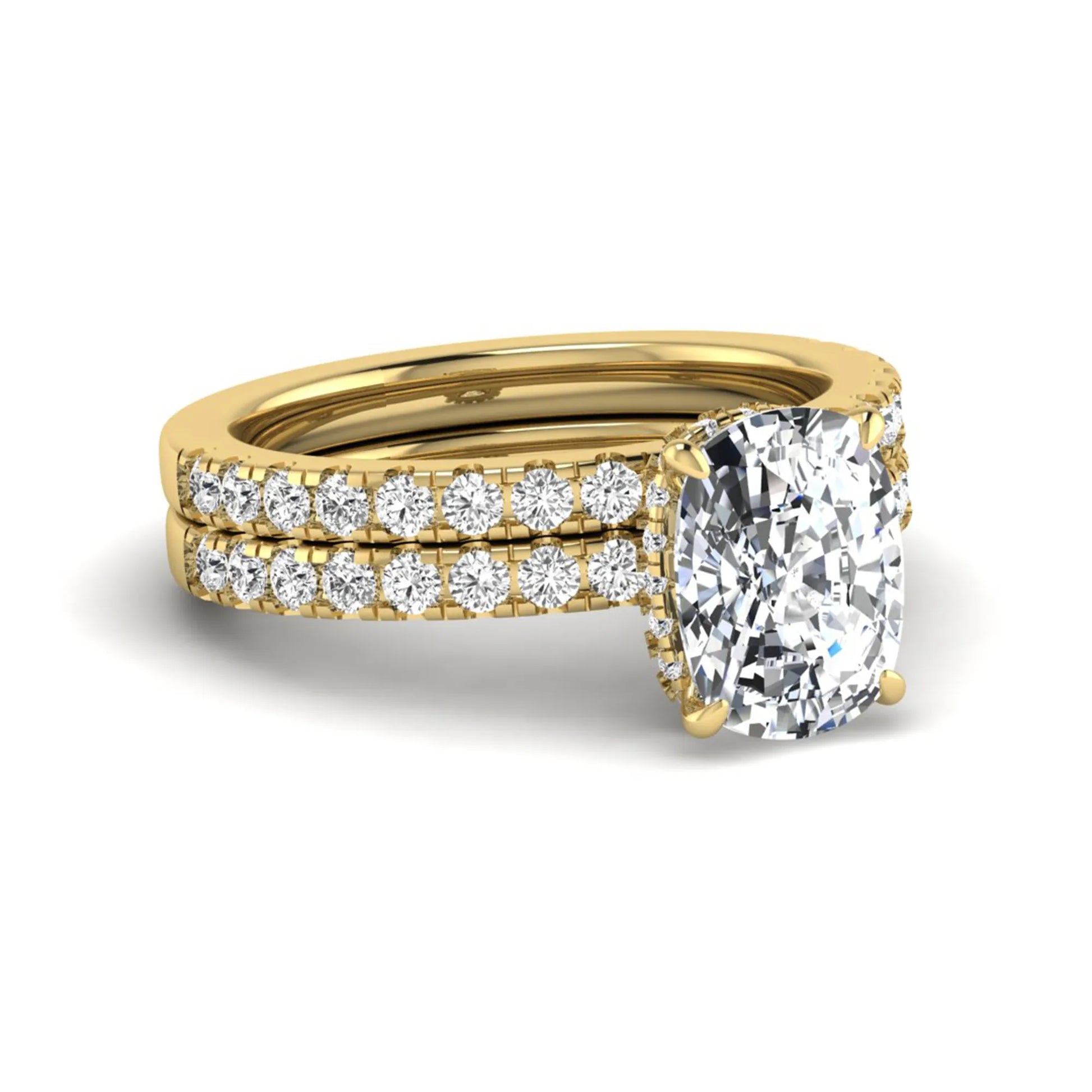 Cushion cut lab grown diamond hidden halo bridal ring set with pavé round diamonds and matching wedding band in a yellow gold tone finish.